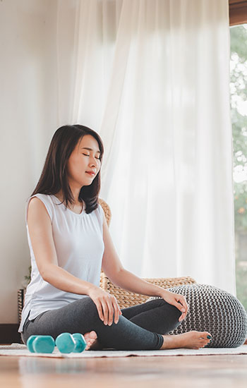 Woman doing yoga meditation at home
